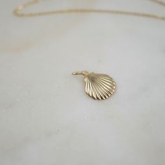 A treasure of the sea, this beautifully crafted 14kt Sea Shell Charm is one of our favorites. A great gift for that ocean loving beauty, shop the Fine Chain and all of their lengths for the perfect set! Size: 11x13mm Material: 14kt Gold Clam, 14/20 Gold Filled Oval Jump-Ring Gold Ocean-inspired Pendant Jewelry, Ocean-inspired Gold Pendant Jewelry, Ocean-inspired Shell-shaped Jewelry Gift, Ocean-inspired Gold Sterling Silver Jewelry, Elegant Shell Jewelry With Lobster Clasp, Elegant Shell-shaped Jewelry With Lobster Clasp, Yellow Gold Pendant Jewelry For The Beach, Elegant Gold Shell With Lobster Clasp, Ocean-inspired 14k Gold Jewelry