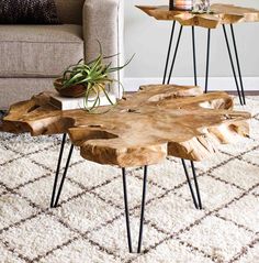 a coffee table made out of wood with hairpin legs and a plant on top