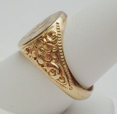 This is a really pretty signet ring from the Art Nouveau period. The ring has an oval signet area that measures 16 x 14 mm. The signet is already hand engraved with a monogram. The sides of the ring has a lovely carved floral design with a beaded edge. This ring is a nice size for either a man or a woman. The ring is stamped 14K and weighs 12.0 grams. The ring is engraved inside M B to P F. The ring is a size 10. *Sizing is available. Please message us for a quote* *We are always willing to ship Luxury Antique Signet Ring With Single Cut Diamonds, Luxury Traditional Carved Rings, Luxury Antique Engraved Filigree Ring, Luxury Vintage Signet Ring With Hallmarks, Luxury Antique Signet Ring Stamped 925, Luxury Vintage Signet Ring With Engraving Option, Luxury Vintage Signet Ring With Polished Finish, Floral Signet Ring, Luxury Silver Art Deco Signet Ring