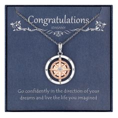 a necklace with a compass on it and an inscription that reads congratulations, go confidently in the direction of your dreams and live the life you