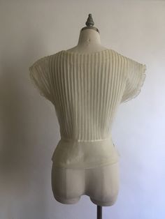 "Gorgeous sheer 1940's short sleeve nylon blouse with lace collar and rhinestones has pretty cap sleeves with a layer of pleated ruffle. Blouse zips up on the side and is in excellent vintage condition. Made by Debcraft and possibly one of the nicest nylon blouses I have come across! Shoulders 15\" Chest up to 36\" Waist 28\" Length from back of neck to hem 18\" Vintage garments have been previously worn and lovingly cared for, they may however have a blemish or two. Here at MadelonVintage, I tr Classic Sheer Evening Tops, Sheer Lace Short Sleeve Top, Sheer Short Sleeve Tops For Evening, Elegant Fitted Tops With Cap Sleeves, Fitted Retro Cream Top, Sheer Fitted Blouse For Daywear, Fitted Sheer Blouse For Daywear, Sheer Short Sleeve Evening Blouse, Fitted Short Sleeve Evening Blouse