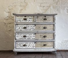 an old dresser with writing on the drawers