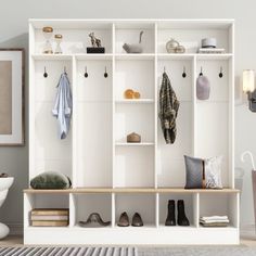 a white shelf filled with shoes and other items