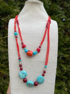 Red Coral With Blue Turquoise Necklace: Material: Gemstone Stone: Coral and Turquoise with Crystal Beads Color: Red and Blue 26 Inch Long Shape: Necklace Used for:  Wearing in a Normal Daily Routine life and any Special occasion These items are made from original and Natural Coral and Turquoise. It is handmade. Radiate style with our Red Coral and Blue Turquoise Necklace featuring red crystal beads. Handmade and uniquely crafted, this piece blends the fiery allure of red coral, the calming touch of blue turquoise, and the glamour of red crystals.  Make a bold statement with this one-of-a-kind necklace, capturing the essence of timeless beauty and vibrant energy.  If you have any kind of Query feel free to Contact us.  Thank You Traditional Red Necklace With Natural Stones, Beach Jewelry With Colorful Beads In Red, Beach Red Jewelry With Colorful Beads, Red Jewelry With Colorful Beads For The Beach, Handmade Turquoise Necklace With Red Coral, Bohemian Turquoise Necklace With Red Coral, Red Polished Bead Necklaces For Beach, Red Round Bead Necklaces For Beach, Red Round Beaded Necklaces For The Beach