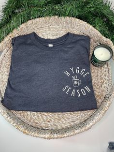 Hygge Season Long Sleeve Tee | Danish T-Shirt Women | Cozy Vibes Shirt | Winter Themed Shirt | Cozy Holiday Shirt | Hygge Lifestyle This Hygge Season long sleeve t shirt is a perfect to snuggle up in with a cup of hot cocoa. Wearing this tshirt will instantly give you Hygge Vibes! We use super soft, high quality Bella Canvas tees. These shirts are Unisex & preshrunk, please see size chart in listing photos for sizing information. Everything is designed, developed, and produced by SunshineSou Cozy Cotton T-shirt With Graphic Print, Cozy Cotton T-shirt For Loungewear, Cozy Crew Neck T-shirt For Loungewear, Cozy Relaxed Fit T-shirt With Graphic Print, Cozy Letter Print T-shirt For Loungewear, Cozy Cotton Top With Graphic Print, Cozy Cotton T-shirt With Letter Print, Cozy T-shirt With Letter Print For Loungewear, Cozy Crew Neck T-shirt With Letter Print