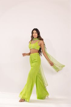 Featuring a neon green glass neck blouse in georgette base. It is paired with a solid crepe matching flared sharara pants having embroidered waist band and net dupatta with lace edging. Color: GREEN FABRIC: GORGETTE Delivery time 15 to 20 days Green Georgette Palazzo Set For Navratri, Green Designer Pant Set For Diwali, Anarkali Style Green Pant Set For Designer Wear, Bollywood Style Pista Green Sharara For Summer, Pista Green Bollywood Sharara For Summer, Floor-length Pista Green Georgette Palazzo Set, Pista Green Georgette Sharara For Navratri, Green Anarkali Pant Set For Wedding, Green Anarkali Pant Set For Eid