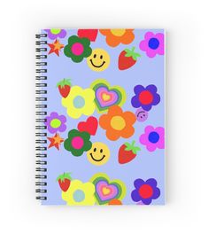 a spiral notebook with colorful flowers and smiley faces