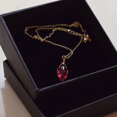 Handmade item Materials: 14k Gold Plated Gemstone: Lab Created Ruby Jewelry type: Necklace Style:  Minimalist Description *Necklace Length : 14inches/16inches/18inches/20inches *Pendant Dimensions : 8mm X 17mm *Chain Thickness : 1.3mm 🌻Tips on Caring for Jewelry: - If you want your jewelry to look new at all times please take jewelry off before showering. - Please keep it away from chemicals, water, and high temperature, it can be too harsh for your stone. - Store it well. A ring box or airtight ziplock bag is the perfect place to keep them. Do not hesitate to contact me with any doubts, I will be happy to help you!  : ) CHECK MORE JEWELRY https://www.etsy.com/shop/CaitlinsJewelryHouse?ref=seller-platform-mcnav Thank you for visiting my shop! 14k Gold Gemstone Necklace For Gift, Ruby Clavicle Chain Jewelry As Gift, Ruby Clavicle Chain Jewelry Gift, Teardrop Jewels Jewelry For Gift, Minimalist Ruby Jewelry As A Gift, Minimalist Ruby Jewelry As Gift, Jeweled Teardrop Necklace As Gift, Oval Pendant Jewelry With Delicate Chain For Gifts, Fine Jewelry Necklace With Jewels For Gift