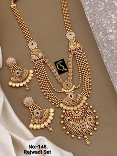 Description :- Gold-Plated Indian Jewelry Set with Long Necklace and Earrings Set, Wedding Function For Women Perfect for Indian weddings. All the raw material used in this product is of high quality and is handcrafted with love. Premium Quality and High craftsmanship 100% Satisfaction Guarantee: Long Lasting Plating, High-Quality Stones. Gifting: This pair of charming necklace and earrings come in a beautiful gift box, making it an ideal gift for birthday, wedding anniversary or wedding gift. O Necklace Set Choker, South Indian Necklace, Necklace Set Indian Bridal Jewelry, Short Silver Necklace, Indian Jewelry Set, Wedding Jewelry Sets Bridal Jewellery, Bridal Necklace Designs, Neck Pieces Jewelry, Bridal Jewelry Vintage