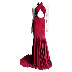 A stunning burgundy fine silk jersey gown by Guy Laroche. It has panels from the side waist crossing the bust, wrapping around the neck leaving a cut out midriff and cut in shoulders in the back. The skirt has center front and back knee length panels joined with ruched sides which create extraordinary fit and enhances the figure. A flared full skirted portion drapes beautifully from the knees and there is a train in the back. This is a stunning dress, amazing on. It has a matching center back zi Unique Red Prom Dresses 2022, Hot Pink Bodycon Dress, 60s Mini Dress, Bandage Dress Herve Leger, Cutout Gown, Gown Red, Vintage Clothes Women, Designer Evening Dresses, Guy Laroche