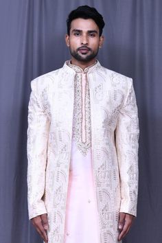 Light pink art silk front-open sherwani with floral, thread and sequins embroidery. Comes with pink banglori silk straight-fit pant and a kurta.
Components: 3
Pattern: Embroidered
Type Of Work: Floral, Thread, Sequins
Neckline: Mandarin collar
Sleeve Type: Full
Fabric: Banglori silk, Sherwani: Art silk
Color: Pink
Other Details: 
Closure: Sherwani and Kurta - Front buttons
Occasion: Wedding - Aza Fashions Open Sherwani, Straight Fit Pants, Tarun Tahiliani, Cocktail Reception, Sequins Embroidery, Pink Art, Modern Bride, Embroidered Silk, Mandarin Collar