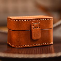 a brown leather box sitting on top of a table