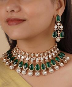 Step into the spotlight with the Urvi Emerald Green Onyx Set, a stunning blend of traditional craftsmanship and contemporary elegance designed to make your wedding day truly unforgettable. This exquisite set includes a statement necklace and matching earrings an Tikka can Be added additionally both featuring the enchanting beauty of emerald green stone . Green Bridal Mossinate Polki Victorian Necklace, Sabyasachi Necklace, Wedding necklace, Semi Precious Jewelry, Bollywood Celebrity Necklace Vic Luxury Festive Necklaces With Stone Work, Fusion Style Diamond Bridal Necklace With Stone Work, Fusion Style Bridal Diamond Necklace With Stone Work, Diamond Kundan Necklace With Meenakari For Receptions, Diamond Chandbali Kundan Necklace For Reception, Diamond Meenakari Chandbali Necklace, Luxury Kundan Jewelry With Stone Work, Luxury Kundan Bridal Necklace With Intricate Design, Festive Kundan Emerald Necklace For Receptions