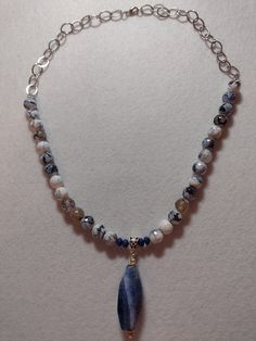 "This Lovely single strand OOAK necklace was made with Blue and White Dragons Vein Faceted Rounds and Lapis Lazuli Rondelles. In the Center is a Blue Dragon's Vein Pendant. Chain and Findings are Silver Plate. Length:  Necklace - Apx 22\", Pendant Apx 2 1/2\"" Blue Beaded Necklaces With Natural Stones And Dangle Shape, Blue Beaded Dangle Necklaces With Natural Stones, Blue Agate Gemstone Beads Necklace, Blue Beaded Necklaces With Natural Stones, Handmade Sodalite Round Bead Necklaces, Blue Dangle Necklaces With Spiritual Style, Handmade Sodalite Round Beads Necklace, Spiritual Blue Dangle Necklaces, Blue Spiritual Necklace