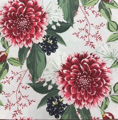 red and green flowers on white fabric with black berries, leaves and stems in the center