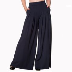 Size: Xs Color: Night Blue Material: 90% Cotton, 10% Elastane Description: Banned Retro Beautiful Pair Of Night Blue Wide Leg Elastic Waistband, With Side Pockets And Hidden Back Zipper. Vintage Meets Gypsy! These 70s Indiana Trousers In Night Blue Are Playful, Stylish And Comfy At The Same Time! The Feminine Elastic High Waist Forms A Beautiful Contrast With The Wide Leg And Is Very Flattering, Also With Fuller Hips/Bottom. The Gorgeous Pleats Finish Off The Easy Going, Laid Back Look. Made Fro Retro Bottoms For Spring Night Out, Retro Spring Bottoms For Night Out, Retro Bottoms For Night Out In Spring, Retro Wide Leg Bottoms For Night Out, Retro Stretch Bottoms For Night Out, Blue High Waist Wide Leg Pants For Night Out, Retro Wide Leg Solid Bottoms, Retro High Waist Solid Bottoms, Black Work Trousers