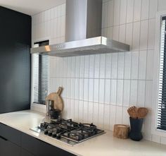 a stove top oven sitting inside of a kitchen