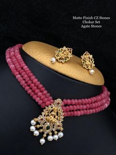 Indian traditional Lakshmi gold finish pendant agate Beaded CHOKER set with matching earrings!! * Three layers * Perfect for festivals, wedding & parties * Budget friendly sets Diwali Gift Jewelry Sets Chandbali Style, Diwali Gift Chandbali Jewelry Sets, Diwali Gift Jewelry Sets Chandbali, Gold Plated Kundan Necklace For Temple Jewelry Gift, Kundan Jewelry Sets Gift For Navratri, Temple Jewelry Style Gold Plated Kundan Necklace As Gift, Festive Jewelry Sets With Round Beads For Gifts, Kundan Jewelry Sets As Navratri Gift, Gold Plated Kundan Necklace For Gift