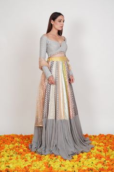 Editor's Note The Multi Pastel Colored Lehenga Set with multiple chanderi patterns is beautified by the gathers at the flare and the Dupatta.Fabric: Chanderi, GeorgetteColor: Pastel greyCare: Dry Clean Only Customize Your Outfit Can't find the size you're looking for? No stress. Just select the size "Custom" while adding the item to your cart. We will follow up with you for your body measurements. To request a color or design customizations, please contact our customer care by using our "Ask us Multicolor Palazzo Set With Sheer Dupatta For Navratri, Multicolor Georgette Sets For Navratri, Multicolor Long Sleeve Traditional Wear With Sheer Dupatta, Anarkali Style Multicolor Palazzo Set For Reception, Multicolor Blouse Piece With Sheer Dupatta For Reception, Multicolor Anarkali Set For Reception And Transitional Season, Festive Multicolor Sharara For Transitional Season, Festive Multicolor Transitional Sharara, Festive Transitional Multicolor Sharara