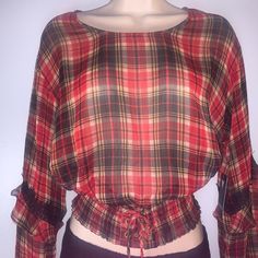 Guess Long Sleeve Sheer Plaid Blouse With A Hint Of Metallic Shine Long Sleeve With Ruffled Overlay And Lace Detail Complete With A Smocked Lace Up Hem/ Waist Crew Neck Size : Small 99% Polyester, 1% Metallic Fabric Type : Chiffon Fitted Casual Plaid Blouse, Plaid Long Sleeve Blouse For Day Out, Red Long Sleeve Daywear Top, Red Long Sleeve Top For Daywear, Plaid Blouse For Fall Day Out, Plaid Blouse For Day Out In Fall, Casual Plaid Blouse With Ruffles, Red Fall Blouse For Daywear, Red Fall Blouse