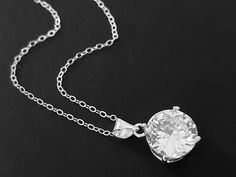 Clear Cubic Zirconia Single Silver Wedding Bridal Pendant Necklace with .925 Sterling Silver Chain. PLEASE READ ITEM DESCRIPTION and SHOP POLICIES before placing your order, and contact me with any questions! CHAIN is 18.00 inches (45.7cm) long. PENDANT is about 0.70 inch (1.8cm) long including bail. BRIDAL NECKLACES SECTION: https://www.etsy.com/shop/LanaChayka?ref=seller-platform-mcnav§ion_id=11638944 BRIDAL EARRINGS SECTION: https://www.etsy.com/shop/LanaChayka?ref=seller-platform-mcnav&secti Diamond White Necklace With Vvs Clarity For Wedding, Wedding Bridal Necklace With Vvs Clarity Round Cut, Round Bridal Necklace With Vvs Clarity For Wedding, Vvs Clarity Round Cut Bridal Necklace For Wedding, Vvs Clarity Round Bridal Necklace, White Gold Bridal Necklace With Vvs Clarity For Weddings, Bridal White Gold Necklace With Vvs Clarity For Wedding, Solitaire Diamond Pendant Necklace For Wedding, Wedding Solitaire Diamond Pendant Necklace