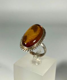 Discover the timeless elegance of our Spectacular Orange Amber Ring, expertly crafted for ladies in stunning 925 sterling silver. This exquisite piece features natural Baltic Sea amber, renowned for its unique beauty and healing properties. Perfect for any occasion, this amber ring will add a touch of sophistication to your jewelry collection. Product Details: Material: 925 Sterling Silver Stone: Natural Baltic Sea Amber Color: Spectacular Orange Design: Minimalist Style Ring Size: 7.1/4 Us size Silver Cabochon Rings Fine Jewelry, Elegant Amber Oval Rings, Classic Amber Rings For Formal Occasions, Classic Sterling Silver Ring, Elegant Oval Amber Rings, Fine Jewelry White Gold Rings With Cabochon, Sterling Silver Ring With Shiny Finish, Elegant Amber Cabochon Ring, Formal Amber Rings In Fine Jewelry Style