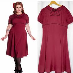 Step Back Into The Glamorous World Of The 1950s With This Stunning Hell Bunny Vixen Retro Style Party Dress In Burgundy! Perfect For Any Occasion, From Parties To Cosplay Events, This Dress Is Designed To Fit And Flatter Any Figure With Its Fit And Flare Style. The Dress Is Made From High-Quality Materials And Is In Very Great Condition, Never Used. The Dress Features A Sailor-Style Collar, Adding A Touch Of Vintage Charm To The Overall Look. The Beautiful Burgundy Colour Is Perfect For Any Seas Rockabilly Vintage Dress For Retro-themed Events, Vintage Short Sleeve Dress For Costume Party, Retro Red Dress For Costume Party, 1950s Style Red A-line Vintage Dress, Red Retro Dress For Vintage Fashion, Red A-line Vintage Dress, Vintage Burgundy Party Dress, Vintage Burgundy Dress For Evening, Vintage Burgundy Evening Dress