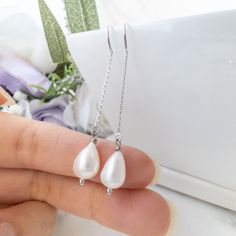 These dainty pearl drop earrings feature lustrous genuine freshwater pearl gemstones, suspended on a delicate chain creating a thread through earrings that is unique and eye catching. Threader earrings are lightweight earrings, which consist of a delicate chain that threads through the earlobe, showcasing the stunning pearls suspended in mid -air for a mesmerizing effect. These pearl earrings are perfect to pair with your summer dresses or wedding guest dresses. Details:---------- - lustrous gen Sterling Silver Pearl Chain Earrings For Anniversary, Delicate Sterling Silver Earrings With Pearl Chain, Dainty Long Drop Pearl Earrings With Ear Wire, Delicate Dangle Linear Earrings With Adjustable Chain, Pearl Drop Dangle Linear Earrings, Silver Teardrop Pearl Chain Earrings, Minimalist Pearl Dangle Linear Earrings, Minimalist Pearl Chain Earrings For Party, Dainty Teardrop Pearl Earrings For Party