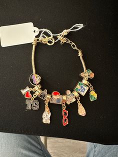 So many iconic moments represented in this charm bracelet!! What’s your fave?!?! Trendy Vintage Charm Jewelry As A Gift, Trendy Vintage Charm Jewelry Gift, Trendy Vintage Charm Jewelry As Gift, Trendy Personalized Metal Charm Bracelet, Personalized Trendy Metal Charm Bracelet, Gold Charm Bracelet As A Souvenir, Trendy Charms With Dangling Details As Gift, Personalized Trendy Charm Bracelet, Metal Bracelet With Logo Charm