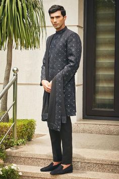 Black sherwani with floral Mughal chikankari embroidery and sequin highlights. Comes with matching dupatta, short kurta and pant.
Components: 4
Pattern: Embroidered
Type Of Work: Chikankari, Sequins
Neckline: Mandarin
Sleeve Type: Straight Full
Fabric: Sherwani and Dupatta- Georgette, Kurta and Pant- Terrywool
Color: Black
Other Details: 
Model height: 6ft, wearing size M
Occasion: Cocktail and Reception - Aza Fashions Designer Sherwani With Mirror Work And Straight Kurta, Eid Bandhgala With Chikankari Embroidery, Designer Kurta With Chikankari Embroidery For Reception, Festive Designer Kurta With Chikankari Embroidery, Designer Kurta With Mirror Work For Eid, Designer Chikankari Embroidered Kurta For Reception, Designer Eid Kurta With Mirror Work, Festive Sherwani With Chikankari Embroidery For Eid, Eid Festive Sherwani With Chikankari Embroidery