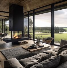 a living room filled with furniture and a fire place in front of a large window