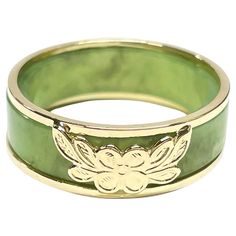 14 Karat Yellow Gold Green Jade Two-Part Ring. Two rings in one, a beautiful light sage green jade band and a yellow gold two band ring with a a four petal flower and leaves at the center. The ring measure 7mm wide and 2.4mm thick. The ring is size 8. The rings together weigh 4.06 grams. Luxury Green Engraved Men's Ring, Gold And Jade Ring, Jade Engagement Ring Green, Jade Gold Ring, Jade Wedding Ring, Jade Engagement Ring, Four Petal Flower, Vintage Engagement Rings Simple, Green Jade Ring