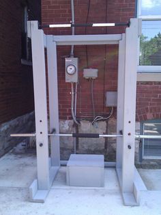 an electrical device in front of a brick building