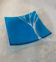 a blue glass plate sitting on top of a table