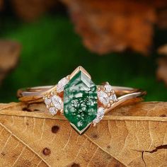 a green ring sitting on top of a leaf