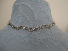 "A highly collectible vintage silver tone panel bracelet by Corocraft. It measures approx 15\" length x 0.25\" width and has a secure ring clasp. Clearly marked hang tag \"Corocraft\" in capital letters preceded by the Pegasus. It is in excellent vintage condition. Postage in the UK is by Royal Mail First Class Signed For service. Postage to all other countries is by Royal Mail Airmail Tracked and Signed For Small Packets service." Handmade Retro Silver Choker, Handmade Silver Retro Choker, Vintage Metal Choker For Formal Occasions, Formal Vintage Metal Choker, Handmade Retro Silver Jewelry, Vintage Silver Choker For Gift, Vintage Silver Choker As Gift, Silver Metal Formal Choker, Formal Silver Metal Choker