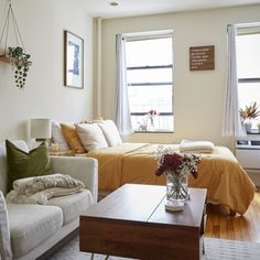 a living room filled with furniture and pictures on the wall