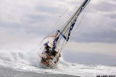 a sailboat in the middle of an ocean wave