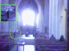 a blurry photo of the inside of a church with benches and pews in it