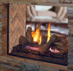 a fireplace with fire and logs in it