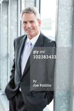 a man in a suit and tie posing for the camera