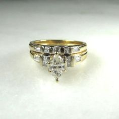 two gold wedding rings with diamond accents on each one and an engagement ring in the middle