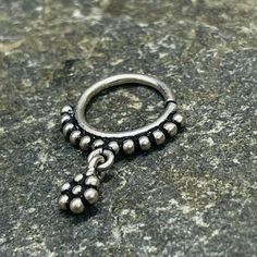 This dazzling silver tribal piece can be worn as a septum, earrings, helix, or tragus . It features a delicate tiny flower hanging in the middle, adding a touch of elegance to any look. 1mm wire - 18 Gauge  Please know your size piercing before making a purchase. All piercings are not returnable due to hygiene and for your safety. Silver Pierced Metal Nose Rings, Elegant Silver Hypoallergenic Septum Ring, Silver Internally Threaded Small Hoop Belly Ring, Nickel Free Silver Metal Nose Rings, Elegant Internally Threaded Silver Septum Ring, Nickel-free Silver Metal Nose Ring, Silver Nickel-free Nose Rings, Elegant Adjustable Silver Nose Rings, Silver Internally Threaded Teardrop Piercings