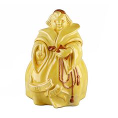 a yellow ceramic figurine with an image of a monk