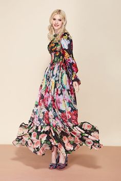 Make a lasting impression in the Designer Flora Dress. Designed in a sheer, floral printed fabric, the maxi gives occasion wear a contemporary edge. Featuring a flattering smocked waist detail, O neckline with ruffle detail, long ruffle sleeves, and a concealed zip fastening. Style with simple heels for an elegant look