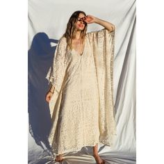 The Mykonos Kaftan is a piece that will elevate your style no matter how you wear it. This Kaftan features a v-neckline perfect for a flattering touch. The dual side-seam slits are oversized and so comfortable. The floral flourishes add a chic and romantic vibe, perfect for a candle-lit dinner under the stars. 100% Cotton Hand Wash Cold or Dry Clean Only V-neck Unlined Maxi Dress For Beach, V-neck Lined Maxi Dress For Daywear, Unlined V-neck Maxi Dress For Beach, Chic Beige V-neck Cover-up, Fitted V-neck Maxi Dress For Beach, Bohemian V-neck Maxi Dress With Side Slits, Unlined V-neck Cover-up For Vacation, Relaxed Fit V-neck Maxi Dress For Vacation, Relaxed Fit V-neck Maxi Dress For Summer