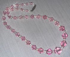 "This is a great vintage 50s pink and white faceted crystal glass beaded necklace.  It is about 18\" long and in good vintage condition.  There are a couple beads with some light wear."