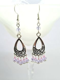 These earrings are handmade. These filigree chandelier drop earrings any young women would want to show off at the festival, carnival these earrings can be given as a Valentines, birthday gift, gift for daughter, neice, mum or a gift for her.  These boho hippie dangle earrings, are made with a filigree connecter, small crystal beads, metal bead caps, the earwire is silver plated.  The following items cannot be returned  * earrings (this is for hygiene reasons) * customised items  There are other items that you may like in our shop. We also sell greetings cards which you may like to purchase with your gift. Please visit our shop to see the different designs available. https://www.etsy.com/uk/shop/Amberrosejewelleryuk All items are delivered in a packaging box. Filigree Chandelier Drop Earrings For Festivals, Filigree Teardrop Chandelier Earrings, Teardrop Chandelier Earrings For Party, Teardrop Filigree Chandelier Earrings, Elegant Summer Chandelier Earrings With Dangling Beads, Party Teardrop Chandelier Earrings, Elegant Summer Chandelier Dangle Earrings, Filigree Dangle Chandelier Earrings For Festivals, Teardrop Chandelier Earrings For Festival