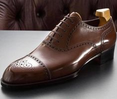 Luxury Cap Toe Lace-up Shoes With Leather Lining, Brown Lace-up Brogue Shoes With Cap Toe, Brown Cap Toe Lace-up Shoes With Leather Sole, Brown Leather Oxford Shoes With Rubber Heel Cap, Brown Oxford Leather Shoes With Rubber Heel Cap, Brown Cap Toe Goodyear Welted Lace-up Shoes, Brown Goodyear Welted Cap Toe Lace-up Shoes, Brown Cap Toe Lace-up Shoes With Goodyear Welt, Brown Leather Cap Toe Shoes With Rubber Sole