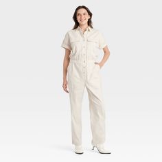 Elevate your wardrobe with this Boilersuit from Universal Thread™. Made from recycled cotton with added spandex, this boilersuit features relaxed-fit legs and an ankle length. The boilersuit comes in a short-sleeve design with a collared neckline and boasts multiple pockets for practicality. The elastic waistband and front buttons add extra flair for an on-trend look. Universal Thread™: Found exclusively at Target. Cream Jumpsuit, Cargo Jumpsuit, Boiler Suit, Spandex Shorts, Women Maxi, Hem Style, Universal Thread, Sleeve Designs, Recycled Cotton